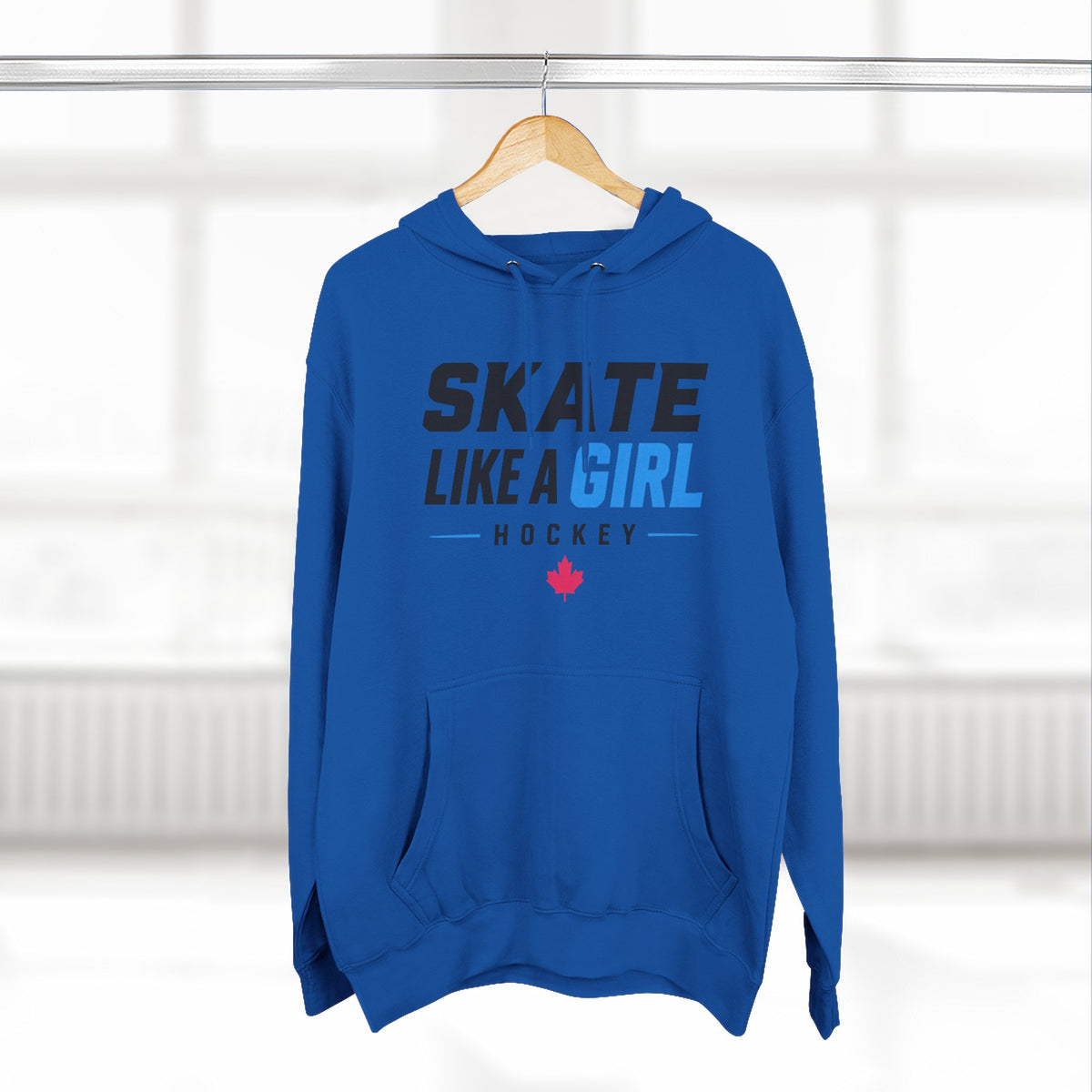 Skate Like A Girl Hockey hoodie in Royal Blue hanging on a rack