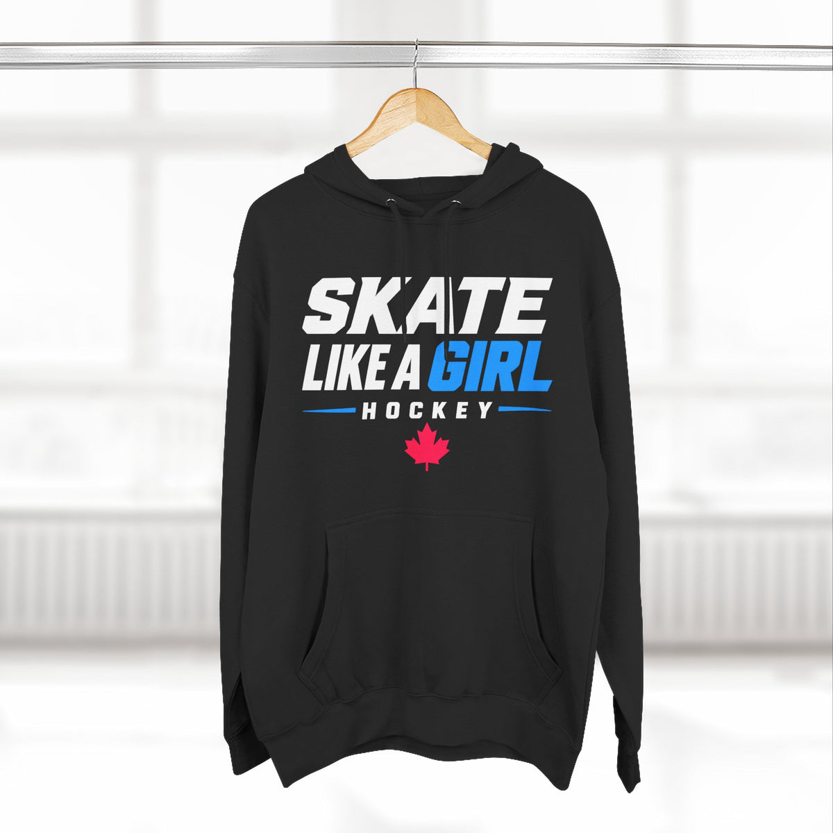 Skate Like A Girl Hockey hoodie in Black hanging on a rack