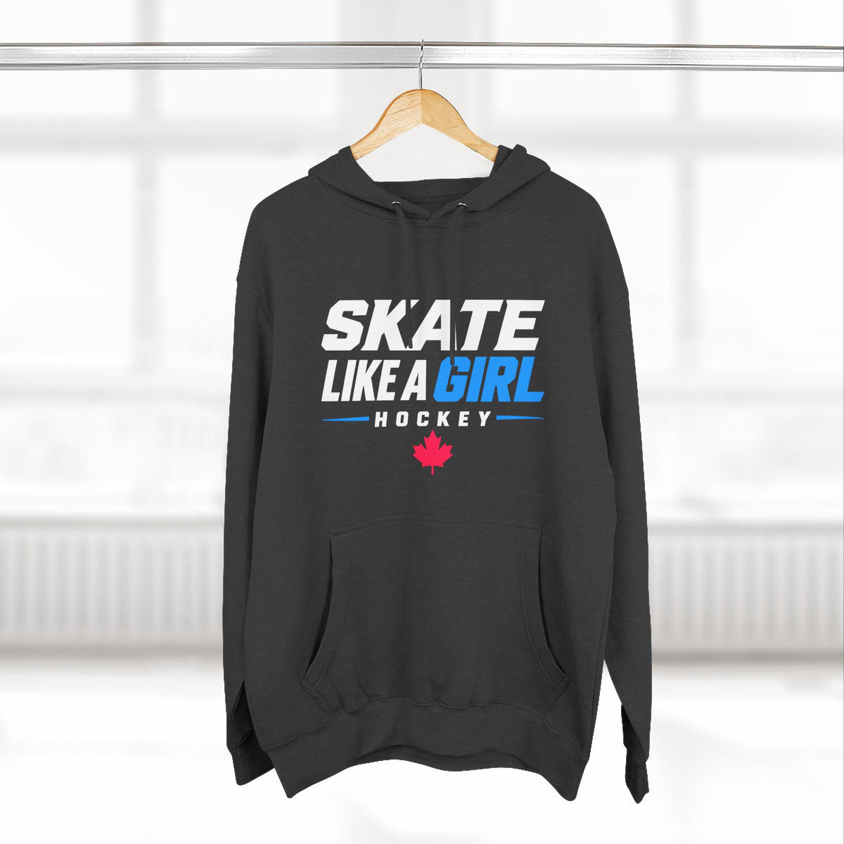 Skate Like A Girl Hockey hoodie in Charcoal Heather hanging on a rack